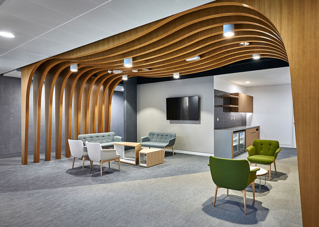 Modern office fit out lounge with curved timber ceiling feature